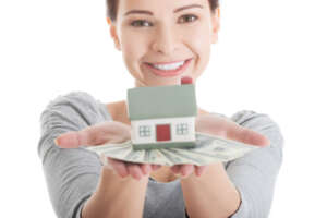 Pro Woman With Money And House Shutterstock 169874009